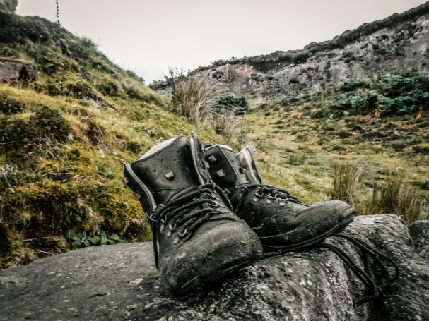 Hiking boots on a mountain trail on the Isle of Skye, Scotland.