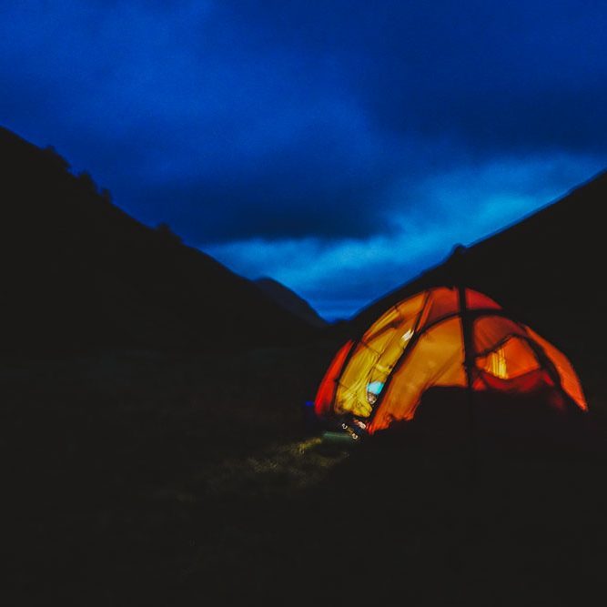 Wild camping Wild camping at night in the Scottish Highlands beneath a dramatic evening sky.