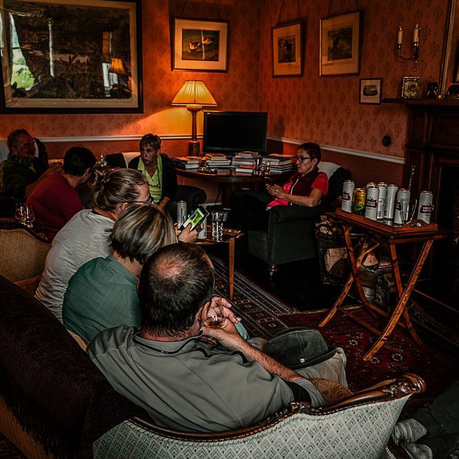 Hiking group Hiking group spending a relaxed evening together at a traditional bed and breakfast in Speyside, Scotland.