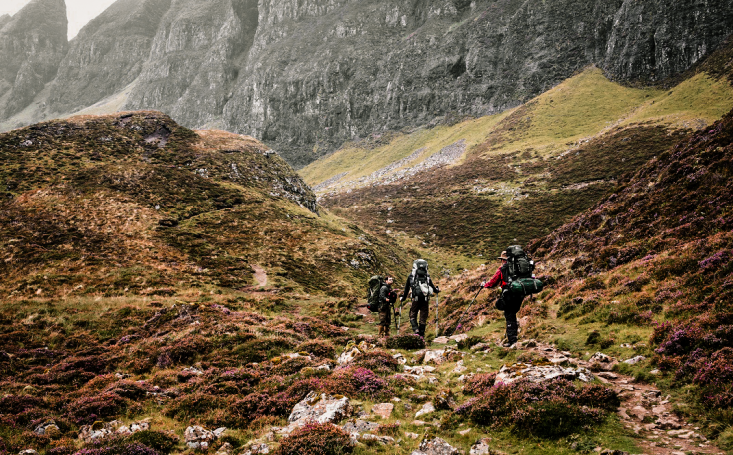 Hiker on the Quiraing landscape on the Isle of Skye, Scotland.