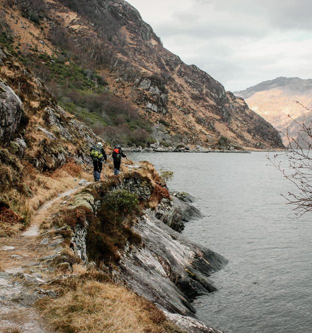 Hikers following Hikers following the shoreline of Loch Nevis in Knoydart, Scottish Highlands.